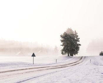 Scenic view of snow covered land against sky