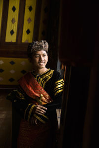 Smiling man wearing king costume looking away