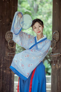 Portrait of a smiling young woman standing outdoors