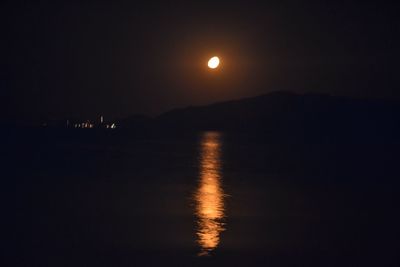 Scenic view of sea against sky at night