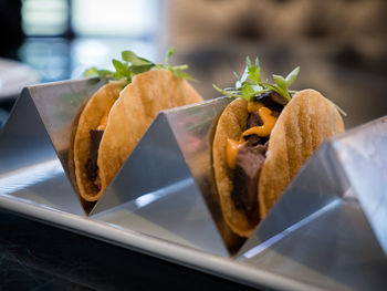Close-up of tacos on metal container