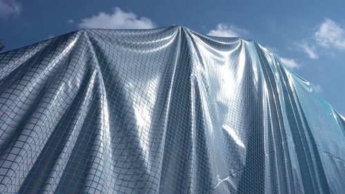 Low angle view of clothes hanging against sky