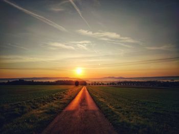 Scenic view of field against sky during sunset