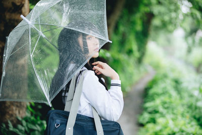 Full length of woman with umbrella