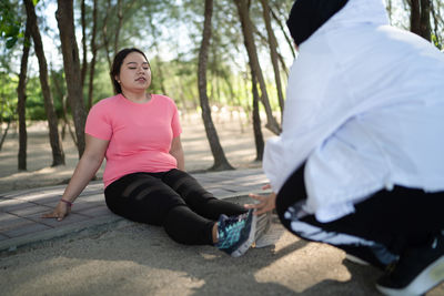 Low angle view of woman exercising in park