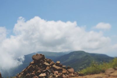 Scenic view of mountains against cloudy sky