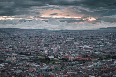 Aerial view of city against sky during sunset