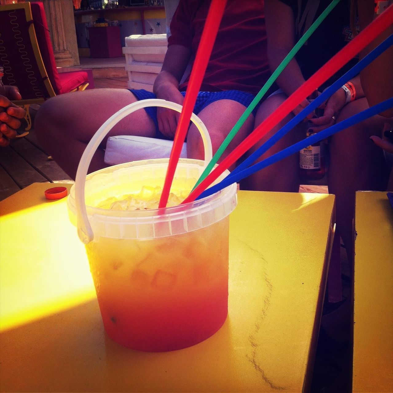 drink, food and drink, yellow, table, indoors, drinking glass, refreshment, still life, drinking straw, close-up, freshness, high angle view, juice, cocktail, focus on foreground, glass - material, alcohol, no people, day, sunlight