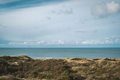 Lonely wave in the calm north sea seen from a dune