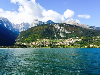 Scenic view of sea and mountains against sky