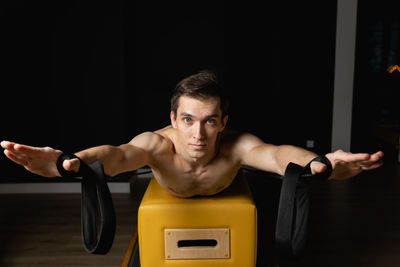 Portrait of young man exercising in gym