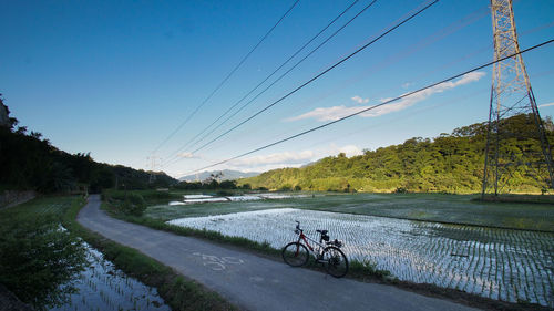 Bike on bike path along electric lines