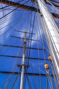 Low angle view of sailboat against blue sky