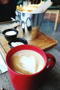 Close-up of cappuccino served on table