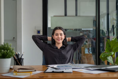 Portrait of young businesswoman working at table