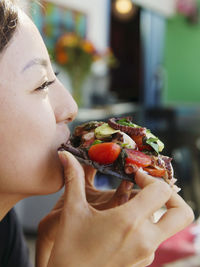 A japanese lady eats a seafood taco in san diego