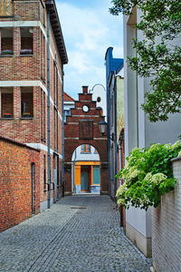 Alley amidst buildings against sky