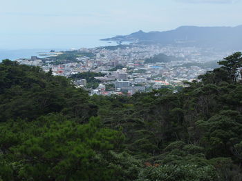 High angle view of cityscape by sea against sky