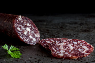 Close-up of fresh salami sausage on granite