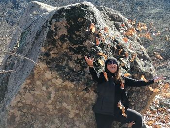 High angle portrait of young woman standing on rock