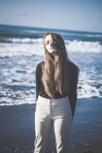 Portrait of teenage girl standing at beach