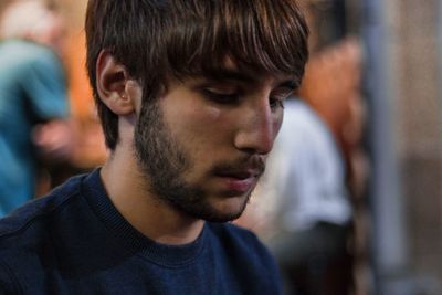 Close-up of young man looking down