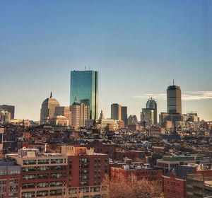 Modern buildings in city against clear sky