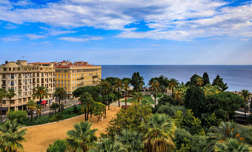 High angle view of townscape by sea against sky