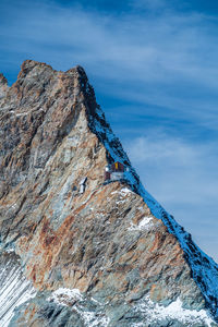 Low angle view of rock formations against sky