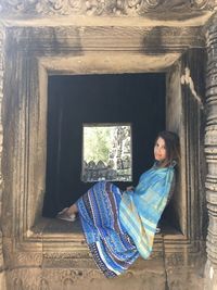 Woman looking through window