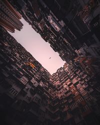 Low angle view of cityscape against sky at night