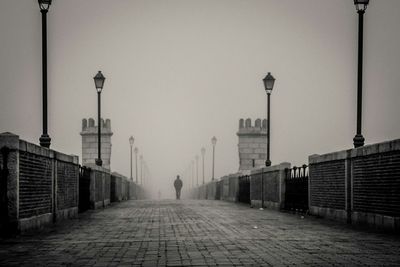 Rear view of man walking on street in city