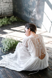 Full length of woman sitting outdoors