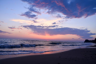 Scenic view of beach against sky during sunset