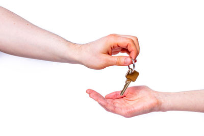 Close-up of hand holding hands against white background