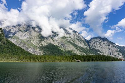 Scenic view of lake by mountains against sky