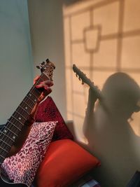 Man playing guitar at home