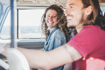 Cheerful friends traveling in vehicle