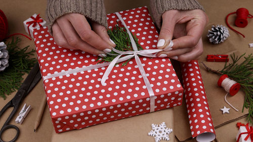 Cropped hands of woman holding gift