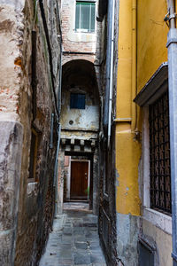 Narrow alley amidst old buildings in city