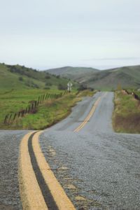 Surface level of road on landscape against sky