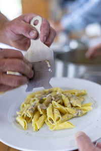 Close-up of person preparing food on table