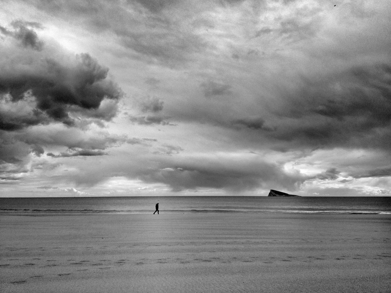 VIEW OF BEACH AGAINST CLOUDY SKY