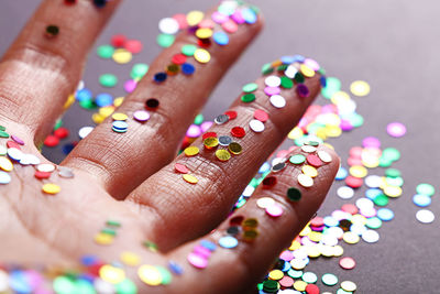 Close-up of hand with colorful sequin