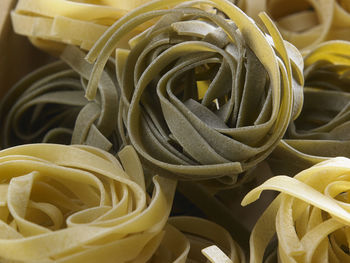 Directly above shot of tagliatelle pasta in crate on table