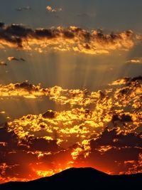 Low angle view of dramatic sky during sunset