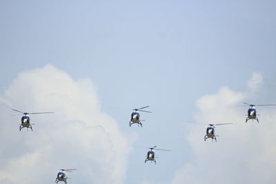 Helicopters on formation with blue sky background