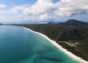 Scenic view of sea and mountains against sky