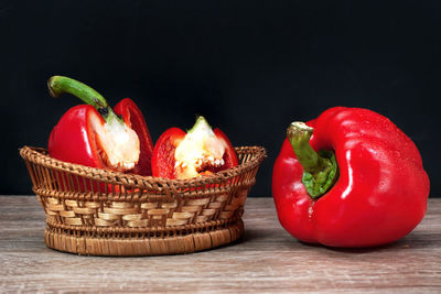 High angle view of red bell peppers in basket on table