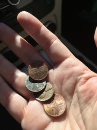 Close-up of hand holding coins